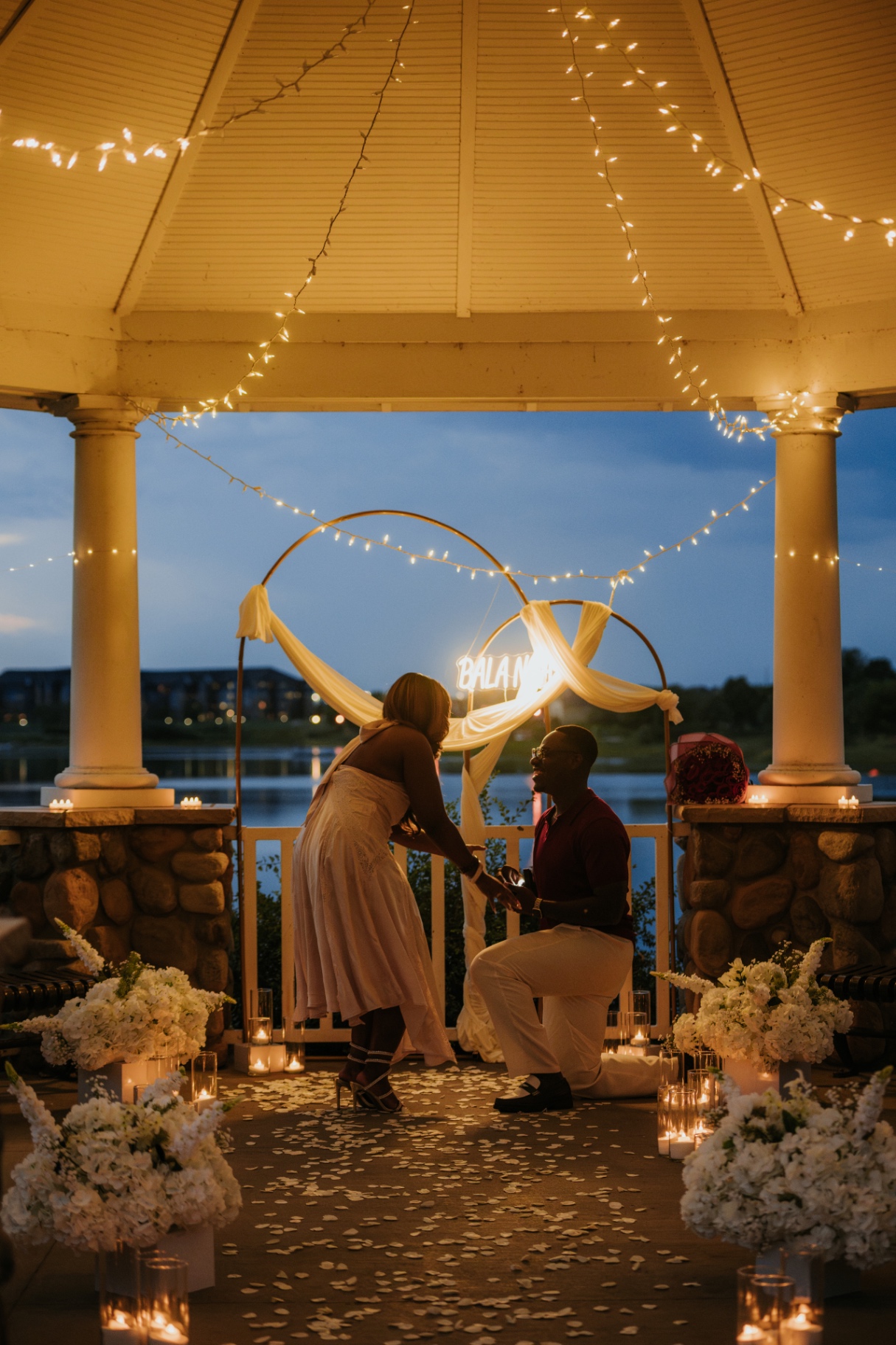 Lael proposing to Riziane beneath the gazebo lights